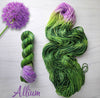Allium - Hand dyed assigned pooling yarn - leafy grass evergreen green with a pop of lilac purple