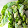 Plant Seeds in the Cracks - Hand dyed yarn, bright green soft teal white avocado lime with teal and purple pink speckles - Andrea Gibson Poetry inspired