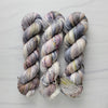 Pebbles in the Sand-  Hand dyed variegated yarn - grey with speckles of brown blue red green