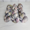 Pebbles in the Sand-  Hand dyed variegated yarn - grey with speckles of brown blue red green
