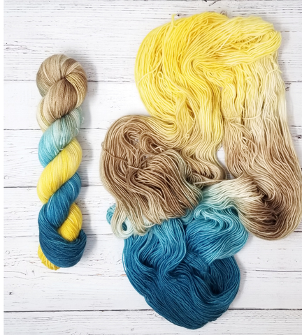 A Touch of the Blues - Hand dyed variegated yarn - gold ivory cream blue teal brown