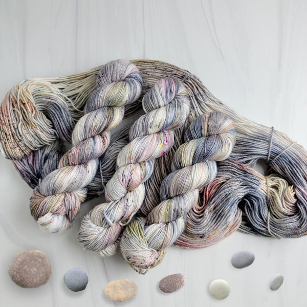 Pebbles in the Sand-  Hand dyed variegated yarn - grey with speckles of brown blue red green