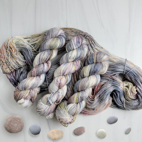 Pebbles in the Sand-  Hand dyed variegated yarn - grey with speckles of brown blue red green