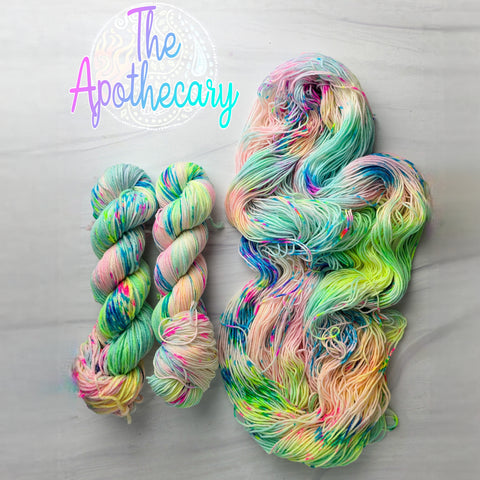 The Apothecary - Hand dyed variegated  yarn, Fingering Weight, inspired by Dungeon Crawler Carl book series - white pastel neon yellow pink blue and splashed in vibrant eon speckles