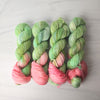 The Spring Court - Hand dyed assigned pooling yarn, Fingering Weight, speckled inspired by ACOTAR by Sarah J Maas - Pastel greens with a peachy pink pop and green speckles