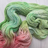 The Spring Court - Hand dyed assigned pooling yarn, Fingering Weight, speckled inspired by ACOTAR by Sarah J Maas - Pastel greens with a peachy pink pop and green speckles