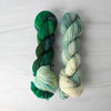 Avallen - Hand dyed Assigned Pooling yarn, Fingering Weight, speckled inspired by the Crescent City series by Sarah J Maas - light puddy green  with a pastel green white speckled color pop