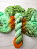 The Life Of A Showgirl - Hand dyed assigned pooling yarn, mint green and moss yarn with a pop of orange -  Taylor Swift inspired yarn