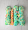 Opalite - Hand dyed, neon pastel green blue yellow with hints of peach  -  Taylor Swift inspired yarn glows under blacklight
