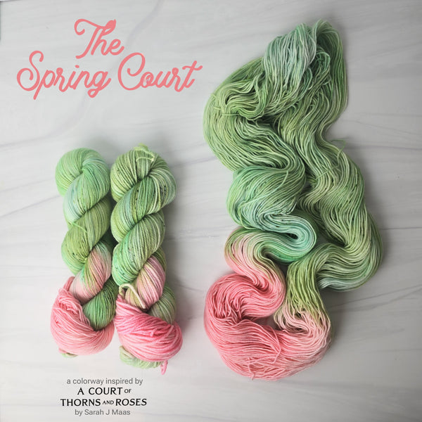 The Spring Court - Hand dyed assigned pooling yarn, Fingering Weight, speckled inspired by ACOTAR by Sarah J Maas - Pastel greens with a peachy pink pop and green speckles