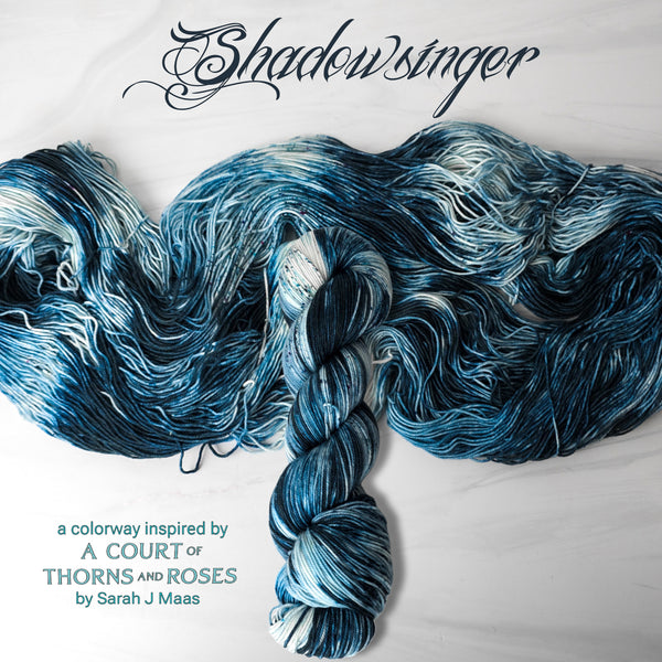 Shadowsinger - Hand dyed yarn, Fingering Weight, speckled assigned pooling inspired by ACOTAR by Sarah J Maas - white with speckles and dark navy teal blue azriel