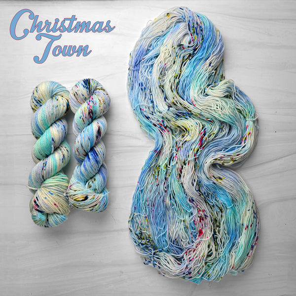 Christmas Town - Hand dyed yarn - Nightmare Before Christmas inspired collection - blue white with speckles of red green peach rainbow