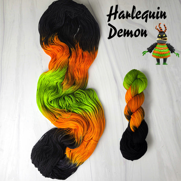 Harlequin Demon - Hand dyed yarn, assigned pooling - Nightmare Before Christmas inspired collection -  black orange neon green glows under blacklight