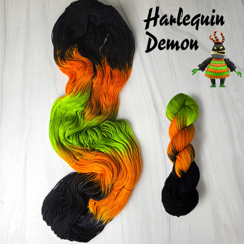 Harlequin Demon - Hand dyed yarn, assigned pooling - Nightmare Before Christmas inspired collection -  black orange neon green glows under blacklight
