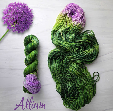 Allium - Hand dyed assigned pooling yarn - leafy grass evergreen green with a pop of lilac purple