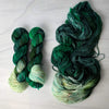 Midgard - Hand dyed Assigned Pooling yarn, Fingering Weight, speckled tonal inspired by the Crescent City series by Sarah J Maas - multiple shades of green verdant kelly moss with a pastel green white speckled color pop