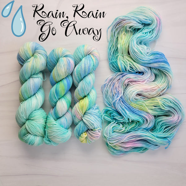 Rain Rain Go Away - Hand dyed variegated yarn -pastel aqua turquoise blue with rainbow pops - lullabies and nursery rhymes collection