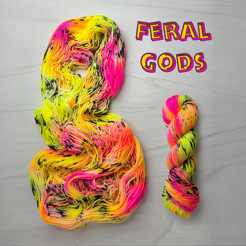 Feral Gods - Hand dyed Assigned Pooling yarn, Fingering Weight, inspired by Dungeon Crawler Carl book series - florescent yellow pink orange with black speckles glows under blacklight