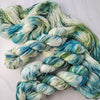 Endless Frozen Pines- Hand dyed variegated yarn - Indie Song Tracks collection - Merino Fingering to worsted dyed to order - white with teal and moss green with pink purple speckles