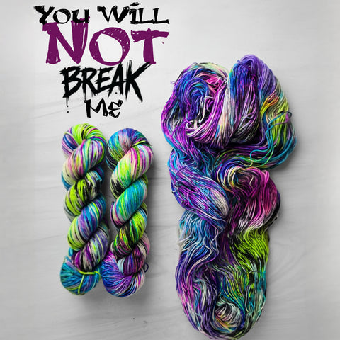 You Will Not Break Me - Hand dyed variegated  yarn, Fingering Weight, inspired by Dungeon Crawler Carl book series - white purple green lime blue splashed in vibrant neon speckles and black