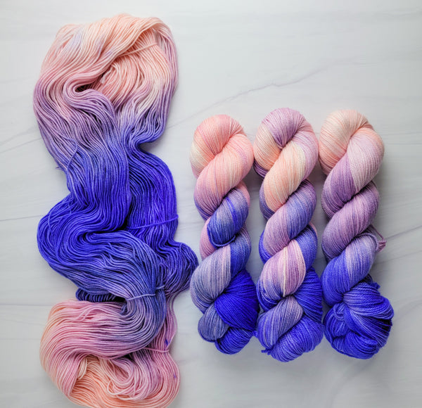 Living Mirage -  Hand dyed variegated yarn - peach pink purple blue violet