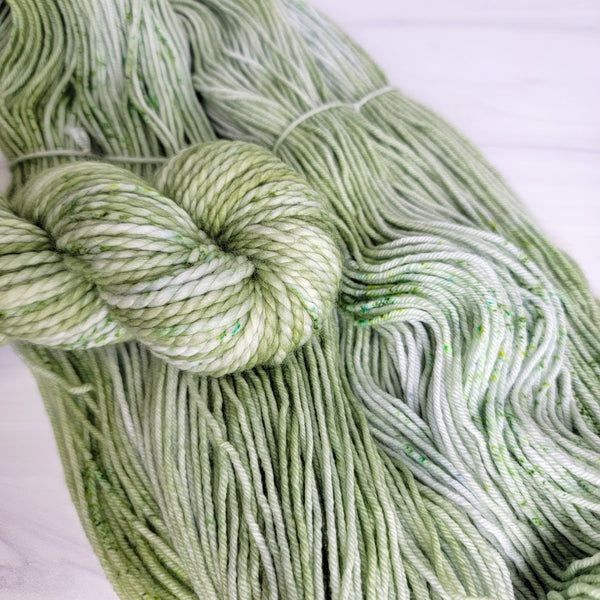 Rhea - Hand dyed Variegated yarn -  Fingering to bulky- Greek Goddess collection pastel sage green with speckles