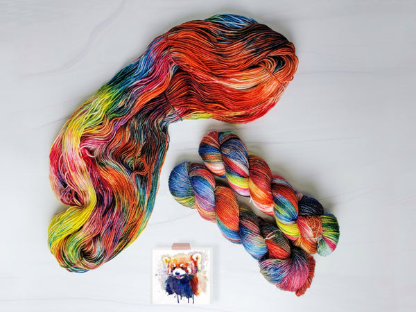 Psychedelic Red Panda - Hand dyed sock yarn - red blue yellow rainbow