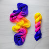 Neon Sunset - Hand dyed yarn, Fingering Weight, florescent fuchsia yellow violet purple glows in black light
