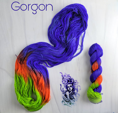 Gorgon - Hand dyed assigned pooling yarn - blue violet, orange, and green glows under black light